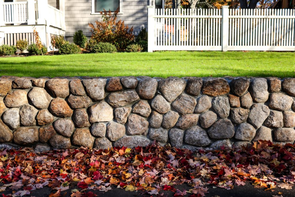 A stone retaining wall is a popular hardscaping feature.
