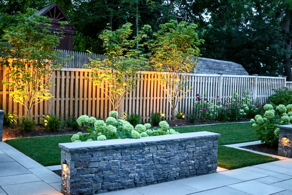 A beautiful 2024 landscape design includes lighting and hardscaping features